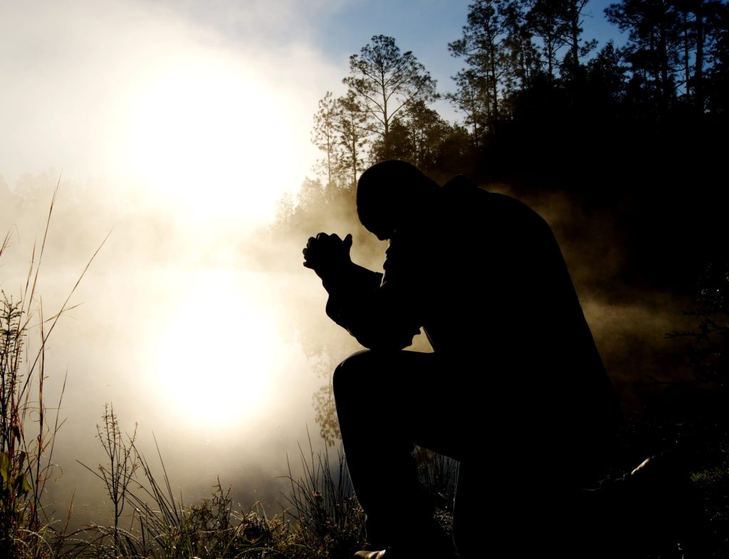 man praying at dusk, pray for your pastor